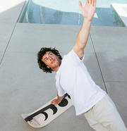 Person planking on a moon slackboard with one arm raised