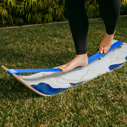 Person balancing on a mountain slackboard on grass
