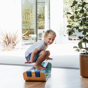 Child playing with a waves slackboard plus indoors