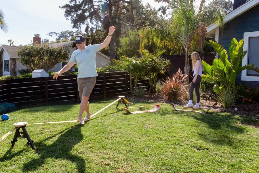 Man walking SlackYard while child watches